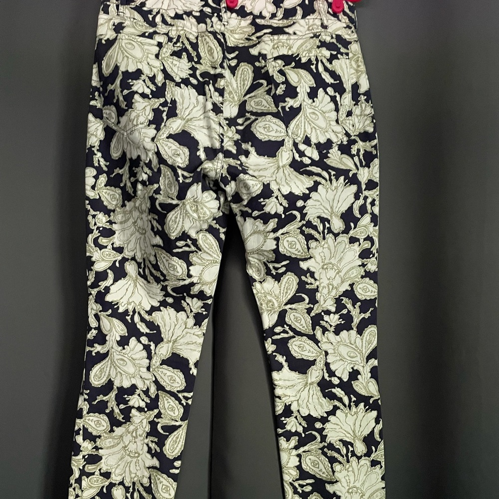 Dark navy, olive green, and cream colored floral design jeans.